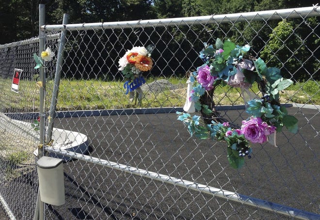 Mementos hang from a chain-link fence that surrounds the site of the 2003 Station nightclub fire.