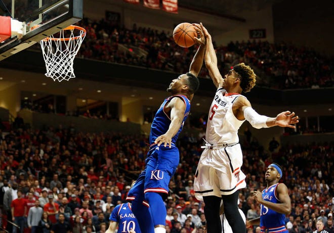 9 January 2015: Texas Tech Red Raiders guard Justin Gray (5) blocks Kansas Jayhawks guard Wayne Seldon Jr. (0) during a game in the United Supermarkets Arena at Lubbock, Texas. (Photo by Zackary Brame/Icon Sportswire) (Icon Sportswire via AP Images)