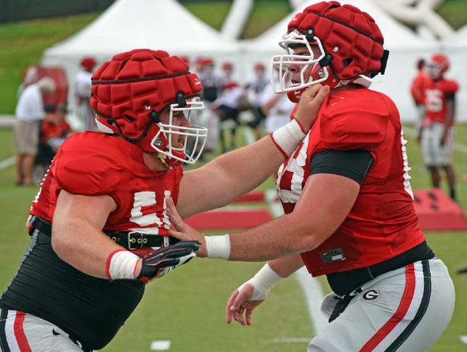 Georgia offensive linemen Brandon Kublanow (54) and Sean Fogarty (68) parry during the Bulldogs' practice on Monday in Athens. (Steven Colquitt/Athens-Banner Herald)