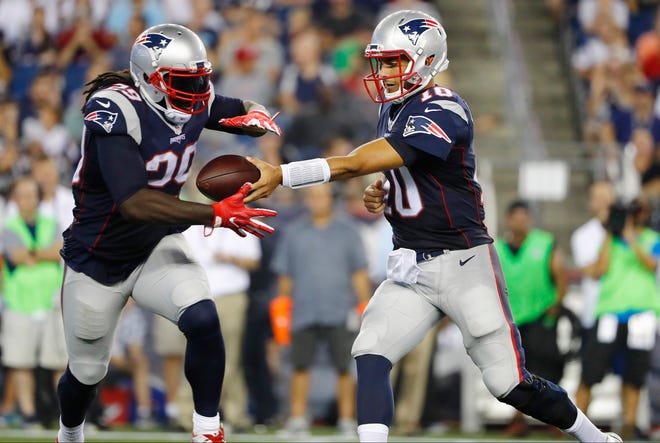 New England Patriots quarterback Jimmy Garoppolo (10) hands off to New England Patriots running back LeGarrette Blount (29) during the first half of a preseason game against the New Orleans Saints Thursday.
