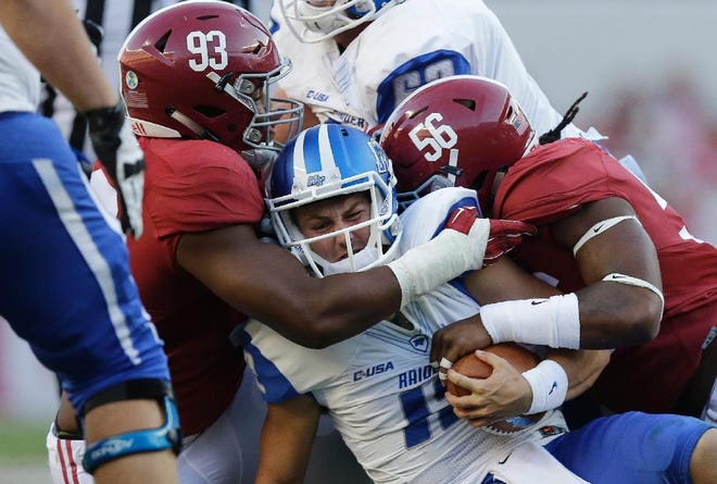 In this Sept. 12, 2015, file photo, Alabama defensive lineman Jonathan Allen (93) and linebacker Tim Williams (56) tackle Middle Tennessee quarterback Brent Stockstill (12) during the second half of an NCAA college football game, in Tuscaloosa, Ala. The defensive front seven might lack last season's tremendous depth, but Jonathan Allen and Tim Williams both put off entering the NFL draft to return after racking up double-digit sacks. (AP Photo/Brynn Anderson, File)
