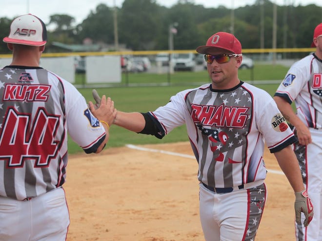 Tech Sgt. Andy Ruehl, with the Ohio Air National Guard, high-fives a teammate after a home run Wednesday during the 51st Air National Guard Softball Tournament at Frank Brown Park.