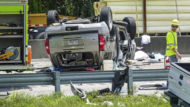 A Chevy Tahoe sits upside down on the Florida Turnpike after it struck a turnpike maintenance vehicle parked on the side of the road Friday morning, August 12, 2016. One person is dead following the three-vehicle wreck near Jupiter. Six people were taken to a hospital. A passenger in the Tahoe died. (Lannis Waters / The Palm Beach Post)