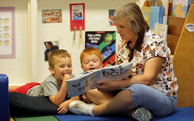 Brittany Randolph/The Star Karen Swofford reads to Liam Leagon, 5, and Payton Nestlerode, 5, at Child Care Center of First Baptist Church in Shelby.