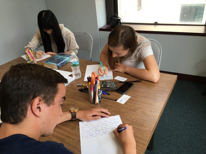 Members of the New Bedford High School Young Alumni group gathered Saturday to writer letters of support to incoming NBHS freshmen. SANDY QUADROS BOWLES/THE STANDARD-TIMES/SCMG