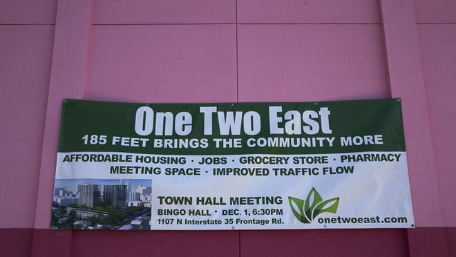 A sign hangs on the building at 12th Street and Interstate 35 last fall calling a town hall meeting about the One Two East project. Many neighbors were concerned the project could accelerate the gentrification of East Austin.