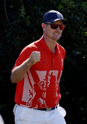 Justin Rose of Great Britain, reacts to making a birdie putt from off the green on the 12th hole during the third round of the men's golf event at the 2016 Summer Olympics in Rio de Janeiro, Brazil, Saturday, Aug. 13, 2016. (AP Photo/Chris Carlson)