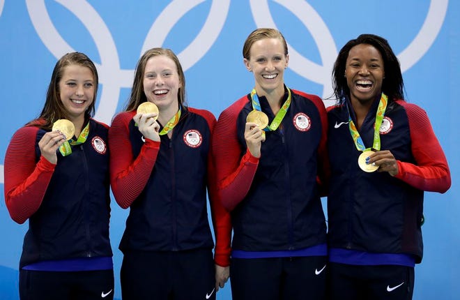 From left, Americans Kathleen Baker, Lilly King, Dana Vollmer and Simone Manuel display the gold medals they earned for winning the women's 4x100-meter medley relay on Saturday.