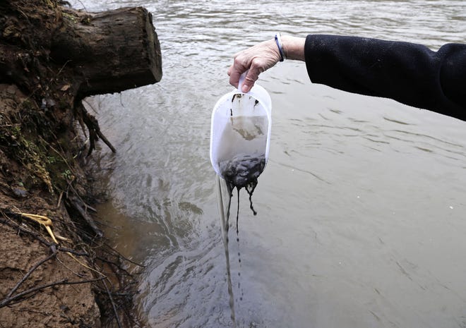 In this Feb. 5, 2014 photo, coal ash is scooped from the banks of the Dan River near Eden, which is north of Greensboro and near the Virginia line. (AP File photo/Gerry Broome)