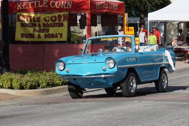 Dave "The Wave" and Margie Derer pull into downtown in their 1962 Amphicar.