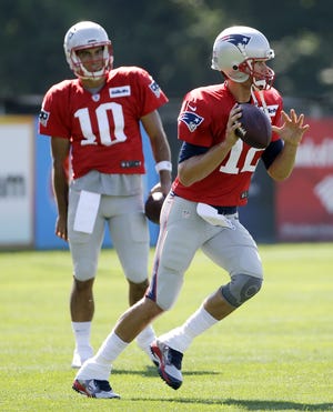 Tom Brady (foreground) said on Sunday that he's been impressed by Jimmy Garoppolo's work ethic in training camp as Garoppolo prepares to start the first four games of the season.
