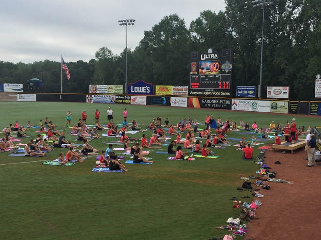Yoga in the Outfield brought more than 160 participants to the stadium Saturday morning. The event raised $1,068 for the American Heart Association in honor of the late Jim Horn. Gabe Whisnant / The Star