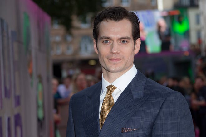 FILE - In this Wednesday, Aug. 3, 2016 file photo, actor Henry Cavill poses for photographers upon arrival at the European Premiere of Suicide Squad, at a central London cinema in Leicester Square. Superman will apparently be back in black. "Man of Steel" star Cavill posted a close-up image of a black Superman uniform Monday, Aug. 15, 2016, on Instagram. He's expected to return in next year's "Justice League." (AP Photo/Joel Ryan, File)