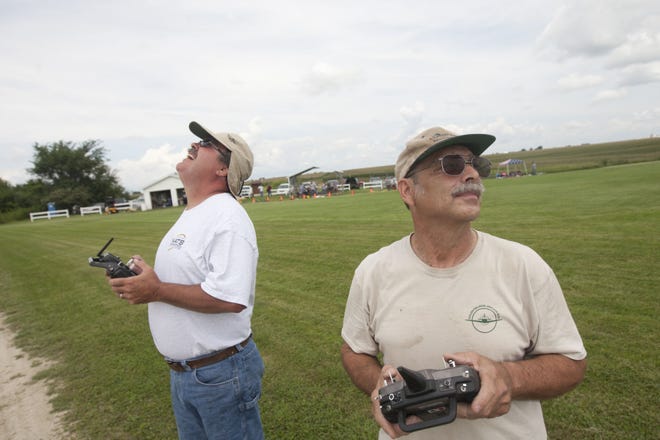 Bollinger, left, and Triska fly their model airplanes in tandem Sunday.