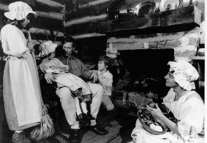 The Moss family dresses up as an 18th century family for the first Backcountry Lifeways event held at The Schiele Museum in 1974. From left, Susan, Meg, Fred, Freddy and Kay Moss sit together around a fireplace. PHOTO COURTESY OF THE SCHIELE MUSEUM.