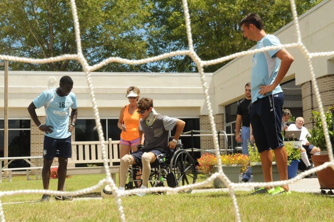 Dillon Brown kicks a goal as Eric Ati and Bruno Perone with the Wilmington Hammerheads soccer team look on. NHRMC has been hosting the Rehab Olympics for its therapy patients. Ken Blevins/StarNews