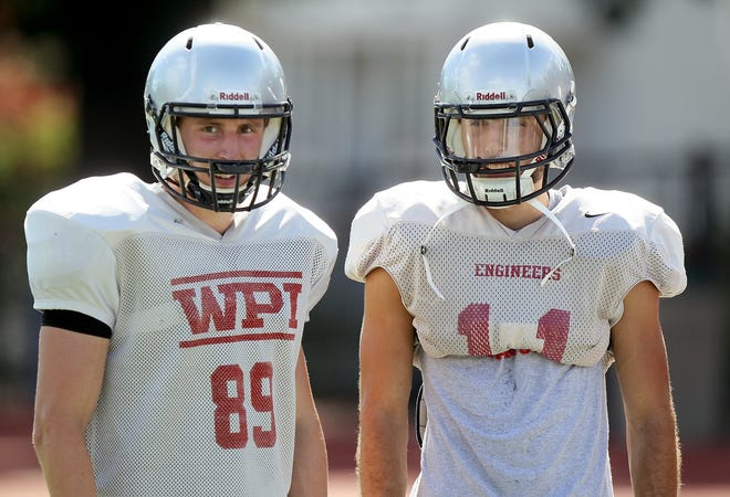 WPI wide receivers Brandon Eccher, left, and Mitch Celaj watch practice on Monday. Photo/Paul Connors