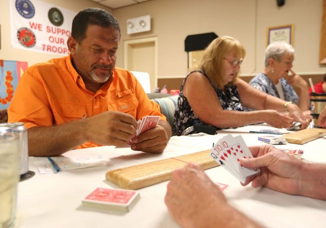 Chuck Dickey looks over his hand during a game of cribbage Aug. 3 at VFW Post 2185 in Panama City.
