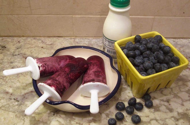 This July 31, 2016 photo shows blueberry and cream ice pops in New York. This dish is from a recipe by Sara Moulton. (Sara Moulton via AP)