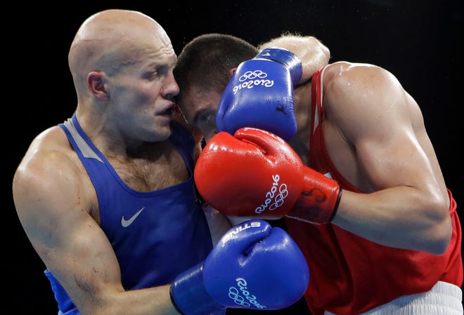 Kazakhstan's Vassiliy Levit, left, fights Russia's Evgeny Tishchenko during a men's heavyweight 91-kg final boxing match at the 2016 Summer Olympics in Rio de Janeiro, Brazil, Monday, Aug. 15, 2016. (AP Photo/Frank Franklin II)