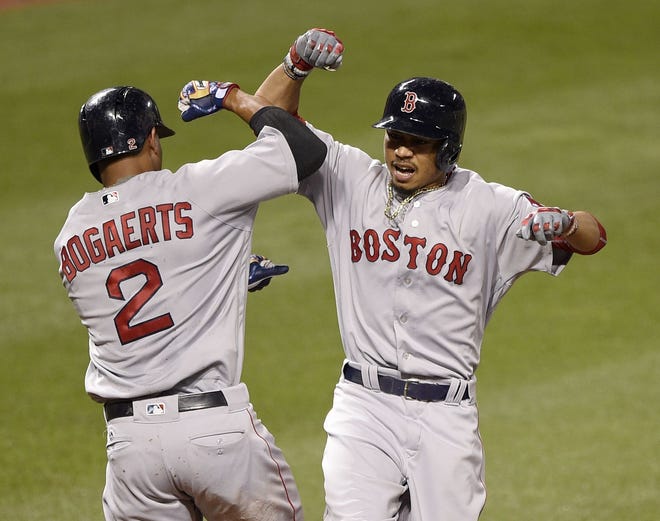 Red Sox outfielder Mookie Betts (right) celebrates with Xander Bogaerts after hitting the first of his two home runs in Boston's 5-3 win over the Orioles on Tuesday night.