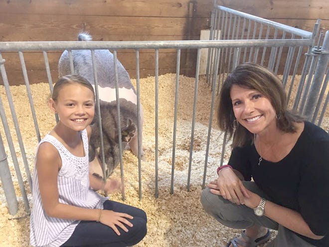 Congresswoman Cheri Bustos, right, posted this photo on Facebook taken with Avery Rash, of Kewanee, and her prize-winning barrow during a visit to the livestock barns at the Illinois State Fair on Friday.