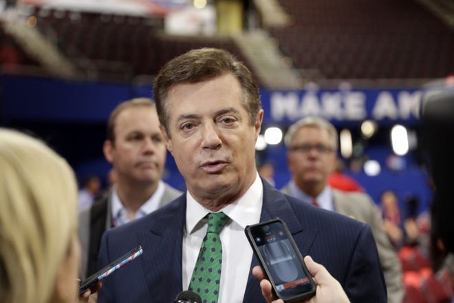 In this July 17 file photo, Trump Campaign Chairman Paul Manafort talks to reporters on the floor of the Republican National Convention at Quicken Loans Arena in Cleveland. Republican Donald Trump announced a shakeup of his campaign leadership Wednesday, the latest sign of tumult in his bid for the White House as his poll numbers slip and only 82 days remain before the election.  AP Photo/Matt Rourke