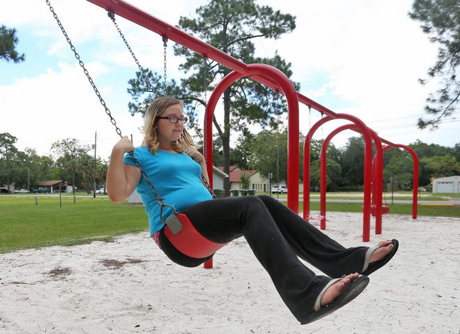Keilianna Martin, 11, relaxes on a swing Wednesday at Sharon Sheffield Park in Lynn Haven. The park was selected to receive two $50,000 grants from the Florida Recreation Development Assistance Program.