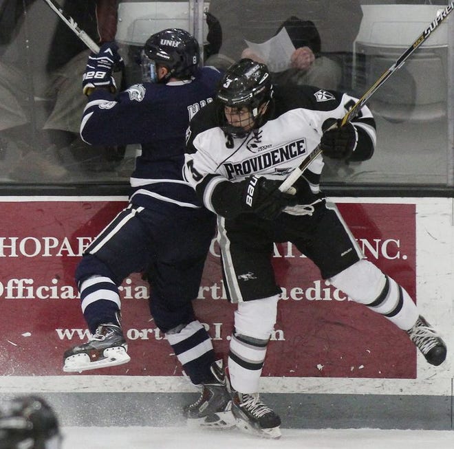 PC's John Gilmour collides with Jamie Hill of New Hampshire in March 2015.
