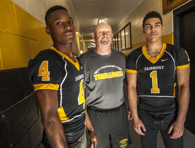 Mark Heil, football coach at Fairmont High School coach of the year Tuesday Dec. 15, 2015 with players Jarique Moore,left, and Julius Caulder, right.
