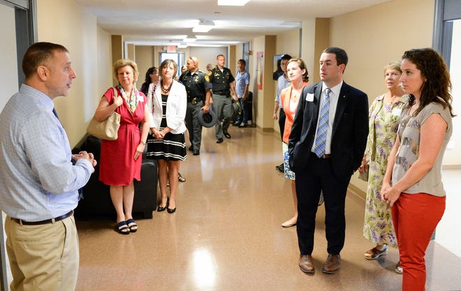 Scott Harhager (left), lead counselor at Wilson Hall, leads a tour of Wilson Hall in Massillon. Sixteen beds were added during the renovation of the third floor of the non-medical residential treatment facililty. (GateHouse Ohio/ Michael Balash)