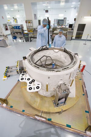 Engineers in the Space Station Processing Facility at the Kennedy Space Center in Cape Canaveral check measurements on the International Docking Adapter on March 24, 2015. NASA ultimately wants two of these 3 1/2-foot-by-5-foot ports at the 250-mile-high International Space Station.