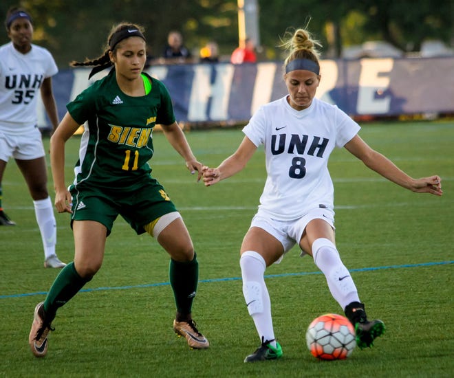 New Hampshire's Madison MacLean (8) works to keep the ball away from Siena's Madison Vasquez (11) Friday night during their game at Bremner Field in Durham. Photoby Shawn St.Hilaire/Fosters.com