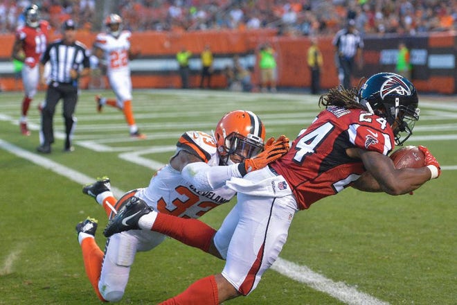 Atlanta Falcons running back Devonta Freeman (24) dives for a touchdown against Cleveland Browns free safety Jordan Poyer (33) in the first half of an NFL preseason football game, Thursday, Aug. 18, 2016, in Cleveland. (AP Photo/David Richard)