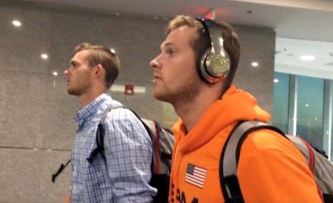 U.S. swimmers Jack Conger and Gunnar Bentz arrive on an overnight flight from Brazil to Miami in Miami in this still frame taken from video on Friday, Aug. 19, 2016. REUTERS/Cassandra Garrison via Reuters TV