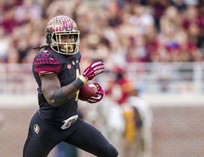 FILE - In this Nov. 21, 2015, file photo, Florida State running back Dalvin Cook runs for a touchdown in the first half of an NCAA college football game in Tallahassee, Fla. It's another year of the running back in college football. LSU's Leonard Fournette, Stanford's Christian McCaffrey, Oregon's Royce Freeman and Cook all are back after rushing for over 1,800 yards last season. (AP Photo/Mark Wallheiser, File)