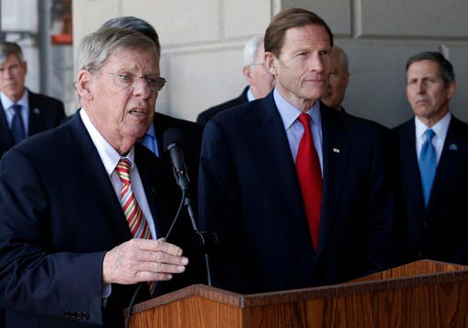 FILE - In an April 24, 2015 file photo, Sen. Johnny Isakson, R-Ga., left, speaks to members of the media following a U.S. Senate delegation tour of the over-budget Veterans Administration hospital complex, which is under construction, in Aurora, Colo. Recent polls show presidential candidates Donald Trump and Hillary Clinton locked in a tight race as the Democrat opens a campaign office in the state and invests in a field organization. Isakson holds a single-digit lead over first-time candidate Jim Barksdale, a wealthy investment manager whose opposition to trade deals and calls for a higher minimum wage has attracted backers of Vermont Sen. Bernie Sanders. (AP Photo/Brennan Linsley, File)