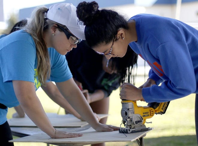 Volunteers with UF's Project Makeover, which does development projects for underprivileged schools in the area, works at Rawlings Elementary in January. (File)