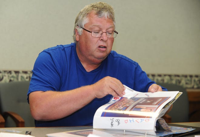 TIMES-REPORTER PAT BURK

Tim Isaacs, father of David Isaacs, leafs through a scrapbook made for David by Tim's fiance Darlene Renner, whom David is accused of killing in March.