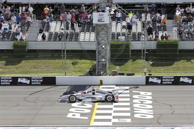 Will Power pumps his fist as he takes the checkered flag to win the IndyCar race at Pocono Raceway on Monday. (AP Photo/Mel Evans)