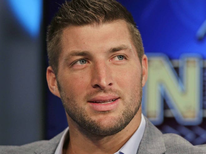 In this Aug. 6, 2014, file photo, Tim Tebow ponders a question during an interview on the set of ESPN's new SEC Network in Charlotte, N.C. With professional football not working out, Tebow is going to give baseball a try. The 2007 Heisman Trophy winner and former NFL first-round draft pick plans to hold a workout for Major League Baseball teams this month. Tebow last played organized baseball in high school. ESPN first reported the news.
