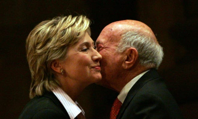 In this Jan. 18, 2006 file photo, then-Sen. Hillary Rodham Clinton, D-N.Y., is greeted by S. Daniel Abraham at Princeton University in Princeton, N.J. More than half the people outside the government who met with Hillary Clinton while she was secretary of state gave money, either personally or through companies or groups, to the Clinton Foundation. It's an extraordinary proportion indicating her possible ethics challenges if elected president.