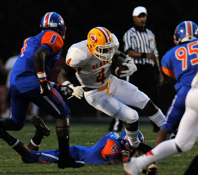Clarke Central's Jaqua Daniels (4) is brought down by Cedar Shoals' Breshawrd Cooper (6) as Clarke Central takes on Cedar Shoals at Cedar Shoals High School on Friday, Sept. 12, 2014 in Athens, Ga.  
(Richard Hamm/Staff) OnlineAthens / Athens Banner-Herald