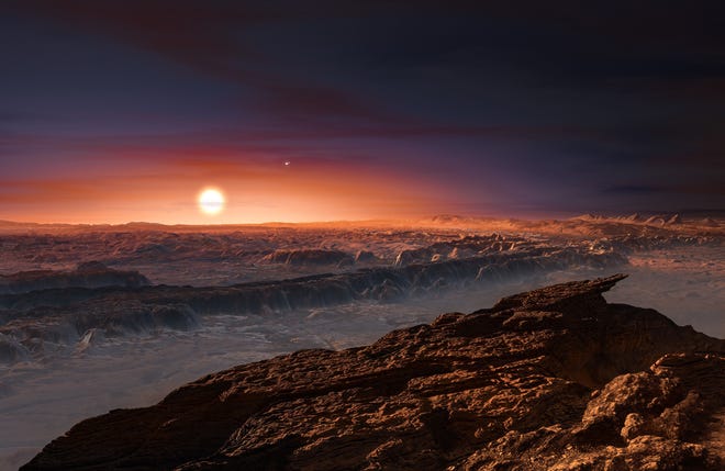 This artist rendering provided by the European Southern Observatory shows a view of the surface of the planet Proxima b orbiting the red dwarf star Proxima Centauri, the closest star to the Solar System. The double star Alpha Centauri AB also appears in the image to the upper-right of Proxima itself. Proxima b is a little more massive than the Earth and orbits in the habitable zone around Proxima Centauri, where the temperature is suitable for liquid water to exist on its surface. (European Southern Observatory via AP)