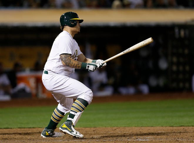 Oakland Athletics' Bruce Maxwell watches his two-run double off Cleveland Indians' Mike Clevinger during the eighth inning of a baseball game Tuesday, Aug. 23, 2016, in Oakland, Calif. (AP Photo/Ben Margot)