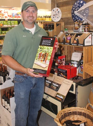 Matt Auclair is pictured next to the barbecue accessories display at Auclair's Market.