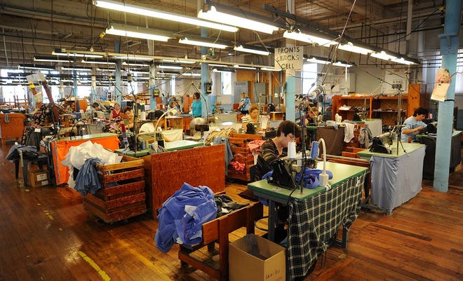 The sound of sewing machines fills the room at the New England Shirt Company on Alden Street in Fall River.