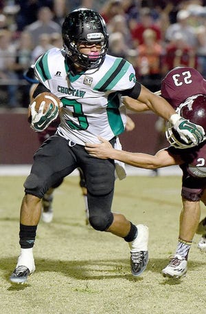 Choctawhatchee's Marquise Kane, left, holds off a tackle from Niceville's Scott
Armfield in a game last season.