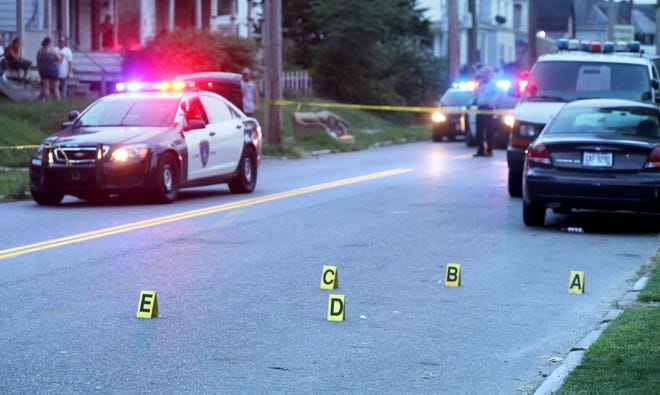 Canton Police mark evidence after three people were shot Wednesday night in the 800 block of Shorb Avenue NW. (CantonRep.com/Scott Heckel)