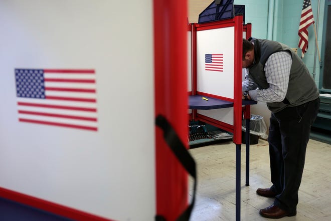 A voter cast his ballots at the Hathaway School polling station in New Bedford. PETER PEREIRA/THE STANDARD-TIMES/SCMG